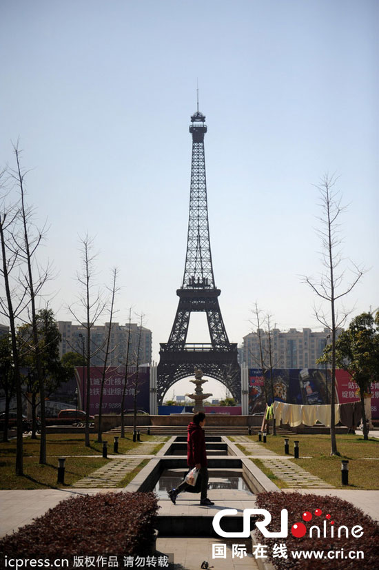 2014年3月21日,杭州天都城,農民在山寨埃菲爾鐵塔下耕作。圖片來源:東方IC 2014年3月21日,杭州天都城,農民在山寨埃菲爾鐵塔下耕作。圖片來源:東方IC