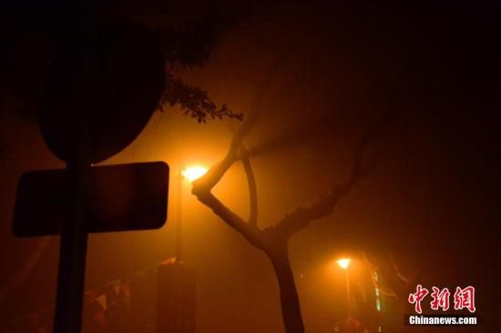 1月31日凌晨，市民行走在煙霧繚繞的南京街頭。當天是農歷馬年正月初一，南京有限開禁燃放煙花爆竹正逢下霧天，空氣的不流通致使煙花爆竹燃燒后產生的顆粒物不能及時散開，造成整座城市煙霧繚繞。據當地環保部門發布的信息顯示，空氣質量屬重度污染。中新社發 泱波 攝