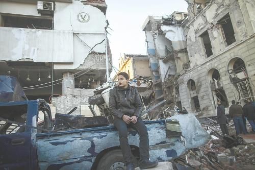 埃及曼蘇拉市警察局24日遭汽車炸彈襲擊，被疑是穆兄會的報復。圖為一名男子在被炸毀的警察局前。