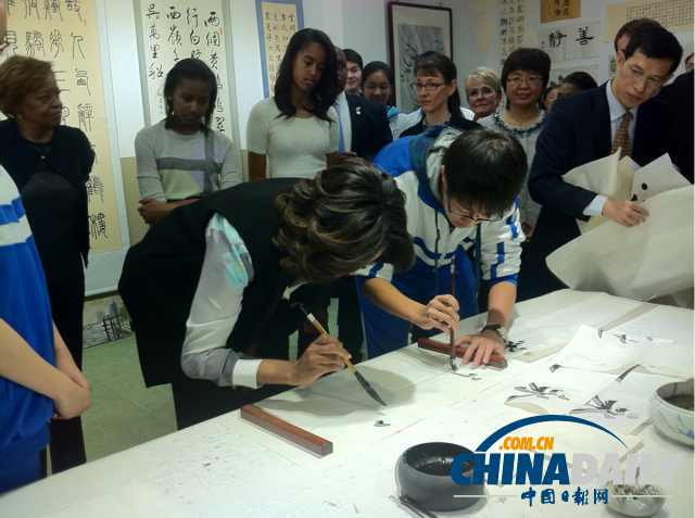 　北京時(shí)間3月21日，美國第一夫人米歇爾參觀北師大二附中時(shí)，與學(xué)生一起練習(xí)書法。