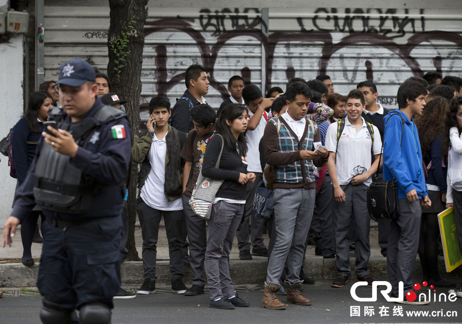 當地時間2014年5月8日,墨西哥墨西哥城,市民等在路邊等待道路重新開啟。 當地時間2014年5月8日,墨西哥墨西哥城,市民等在路邊等待道路重新開啟。
