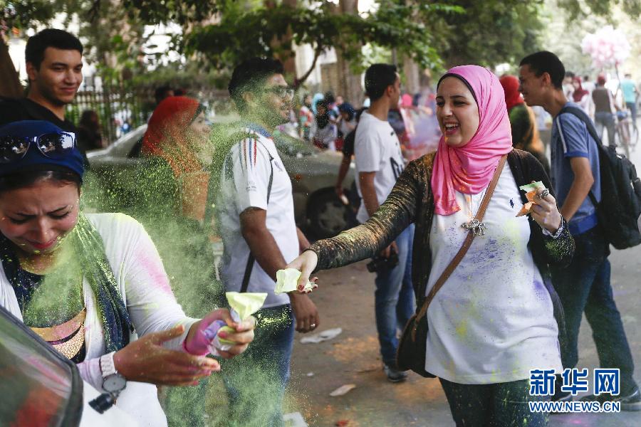 10月16日，在埃及首都開羅，一名女青年在“彩色跑”活動中拋撒彩色粉末。