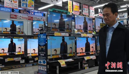 當?shù)貢r間1月20日，日本東京，民眾在電視機前觀看極端組織劫持綁架日本人質(zhì)事件最新播報。