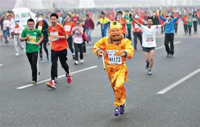 長安街，一名打扮成孫悟空的參賽者在北馬隊伍里飛奔。 本版攝影/新京報記者 吳江 李飛 王嘉寧 吳江